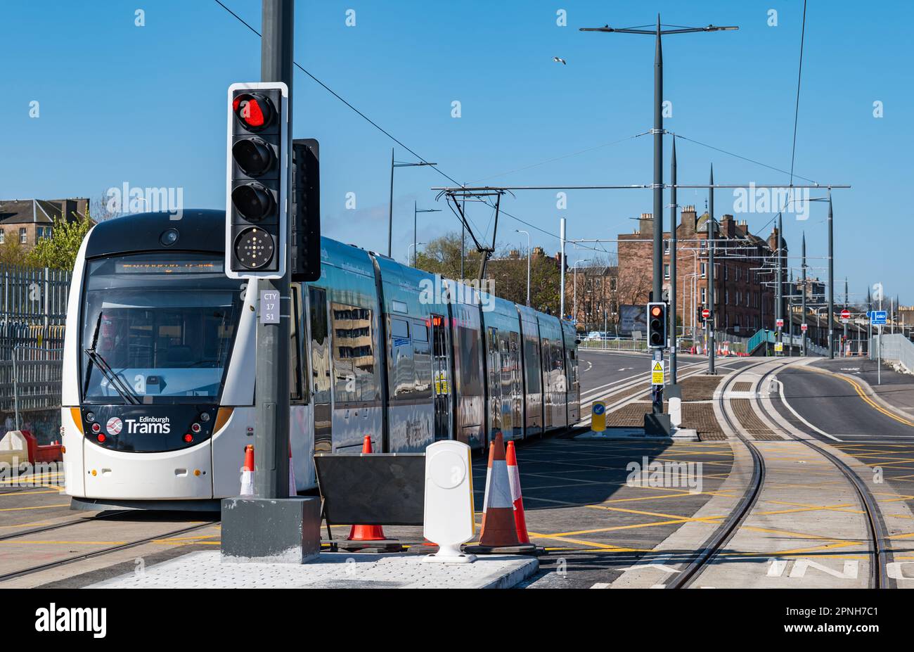 Leith, Edinburgh, Scotland, UK, 19th April 2023. Trams to Newhaven running: the first trams to run on the extended tram line during the day started today to test the route. Pictured: a tram approaching Newhaven tram station, Credit: Sally Anderson/Alamy Live News Stock Photo