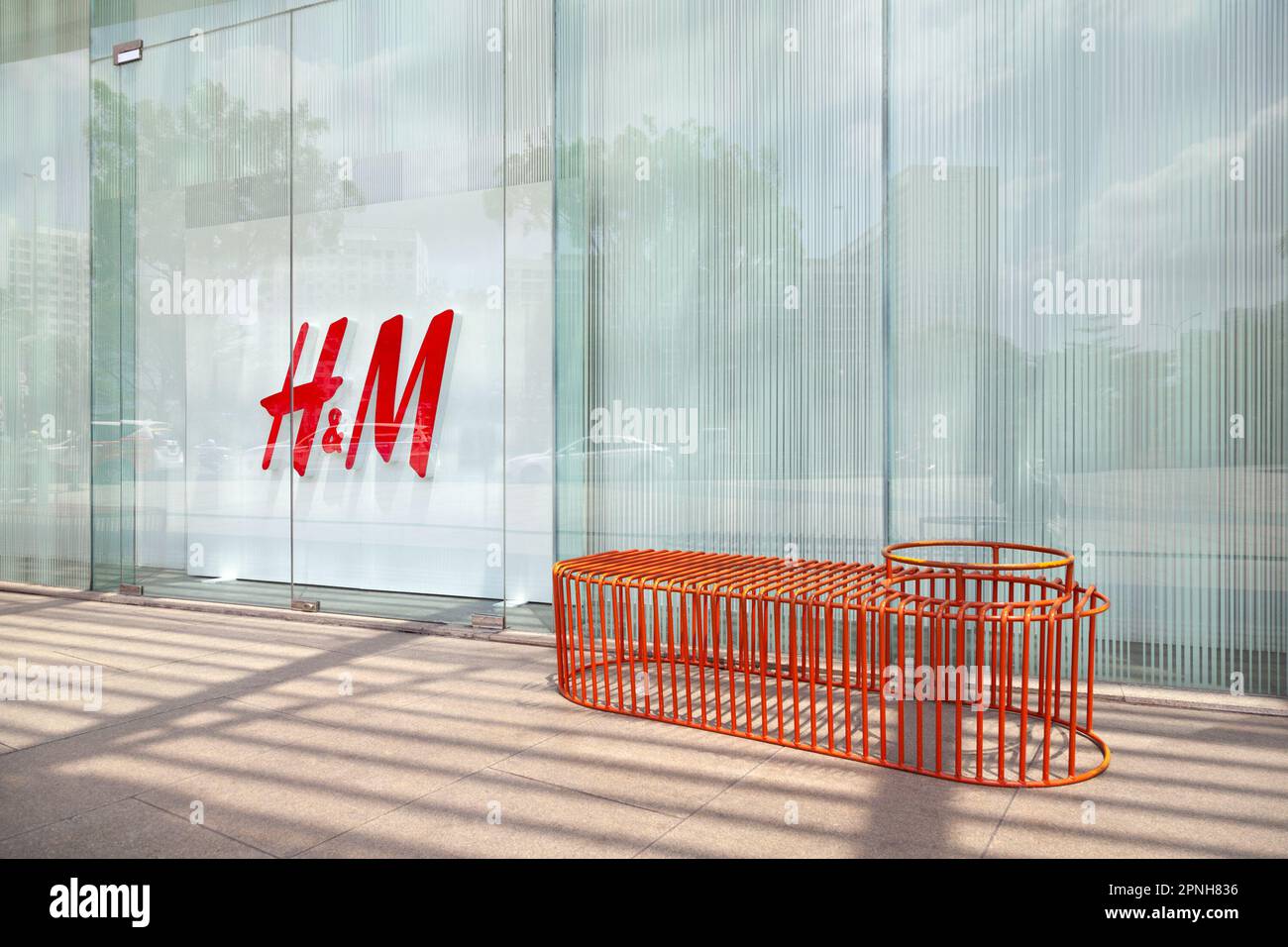 Ho Chi Minh City, Vietnam - April 7, 2023: HM logo on a fast fashion store window. Popular clothing brand sign outside a shopping mall Stock Photo
