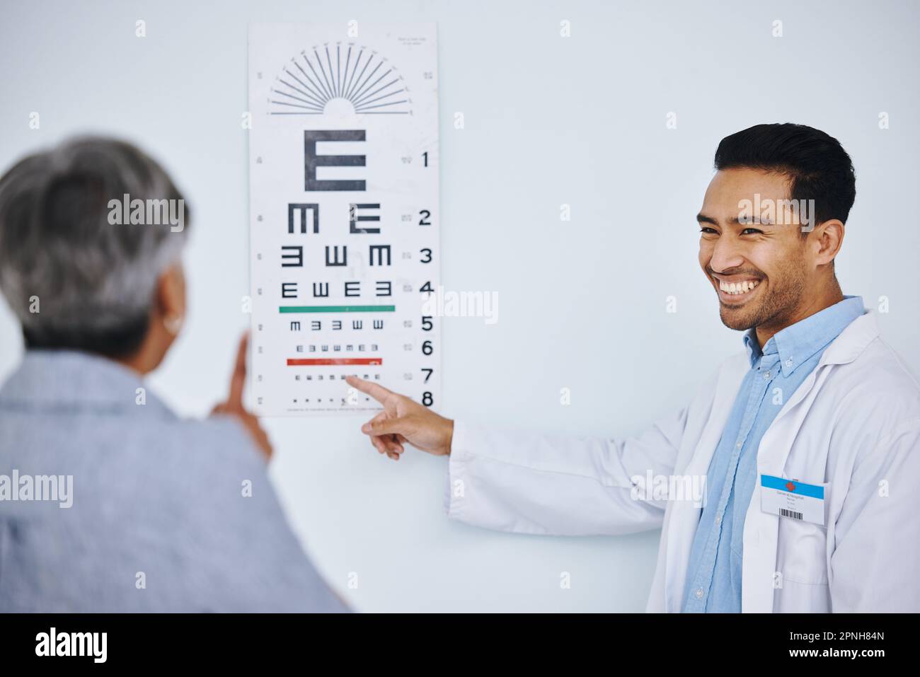 Eye exam, doctor and patient with vision and chart for reading