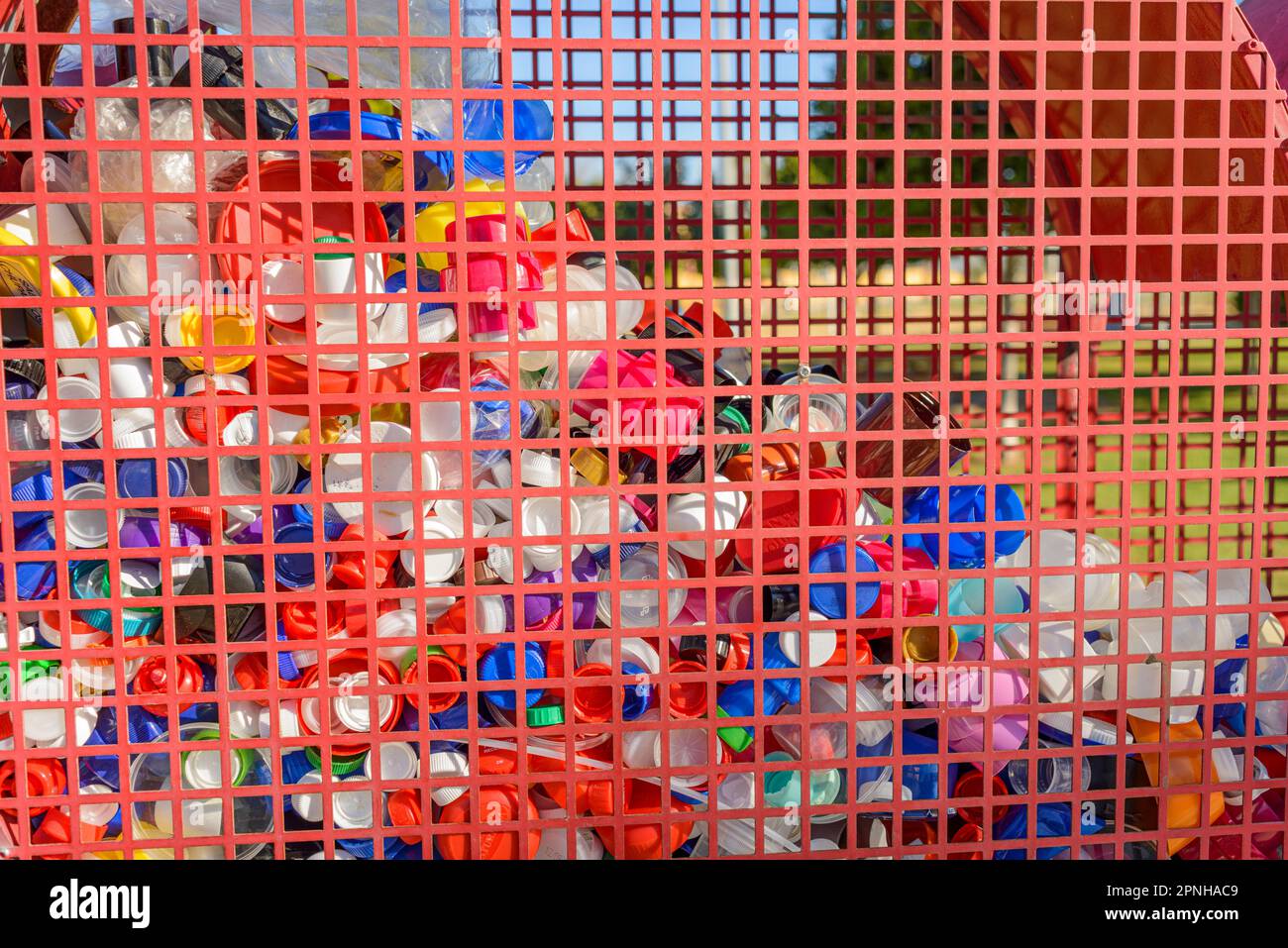 Detail of a container for recycling plastic bottle caps. Recycling