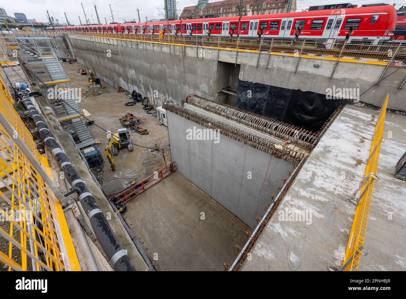 19 April 2023, Bavaria, Munich: A suburban train passes by during a construction site tour of the second main line in Munich. At the 'Tunnelportal West' at the Donnersbergerbrücke, the tracks will in future change from the above-ground to the underground area. Photo: Peter Kneffel/dpa Stock Photo