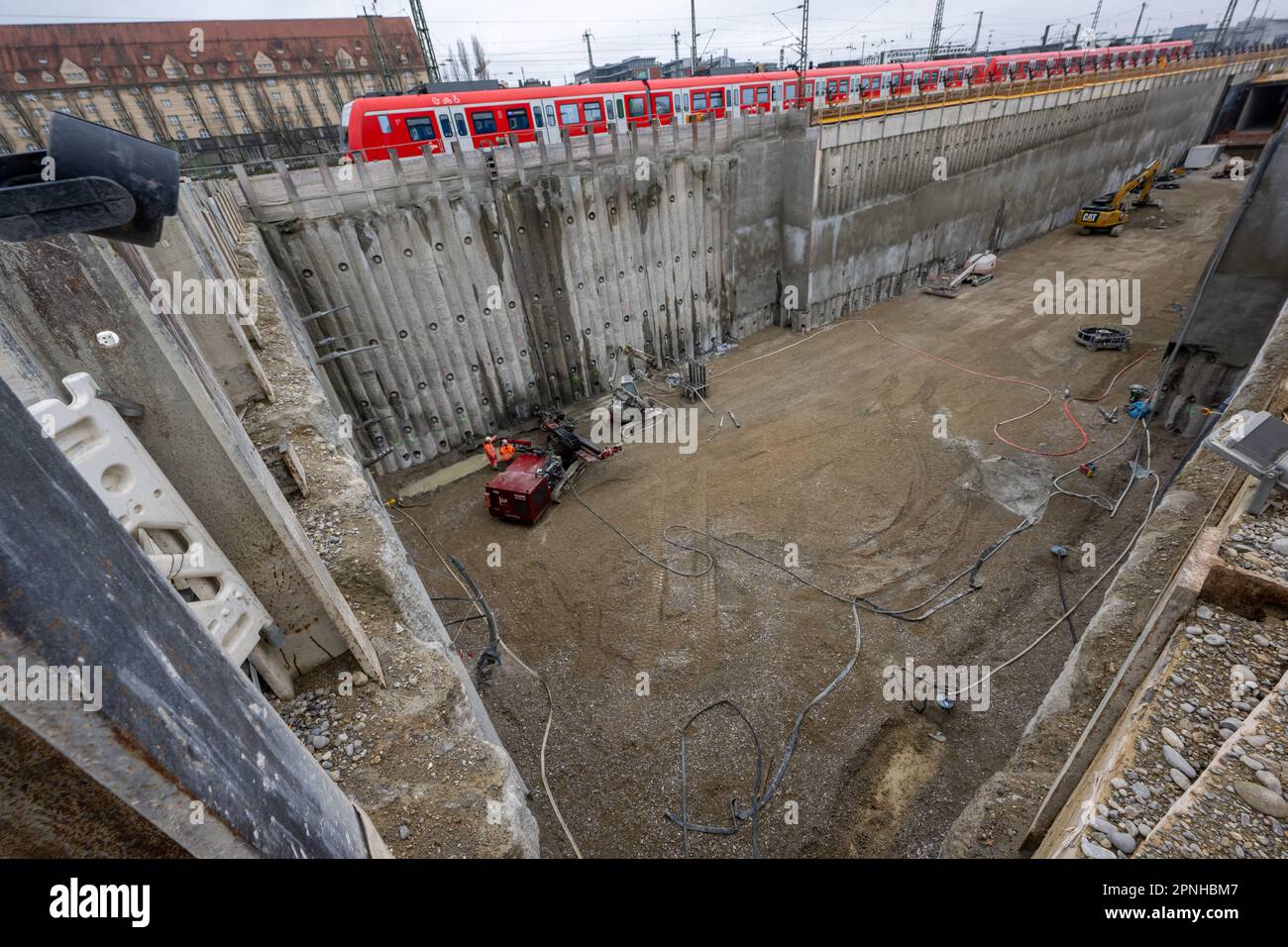 19 April 2023, Bavaria, Munich: A suburban train passes by during a construction site tour of the second main line in Munich. At the 'Tunnelportal West' at the Donnersbergerbrücke, the tracks will in future change from the above-ground to the underground area. Photo: Peter Kneffel/dpa Stock Photo