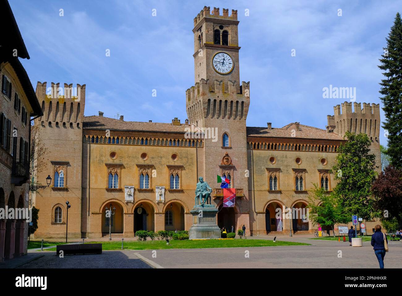 Building of theater Giuseppe Verdi with a tower clock in Busseto, Italy. Square of Giuseppe Verdi Stock Photo