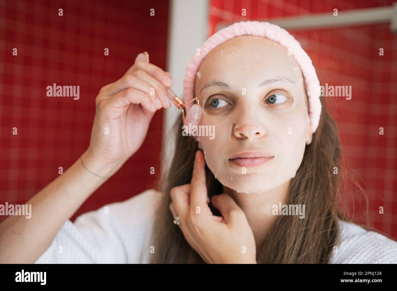 Skincare routine white female in a bright bathroom shaving legs with a