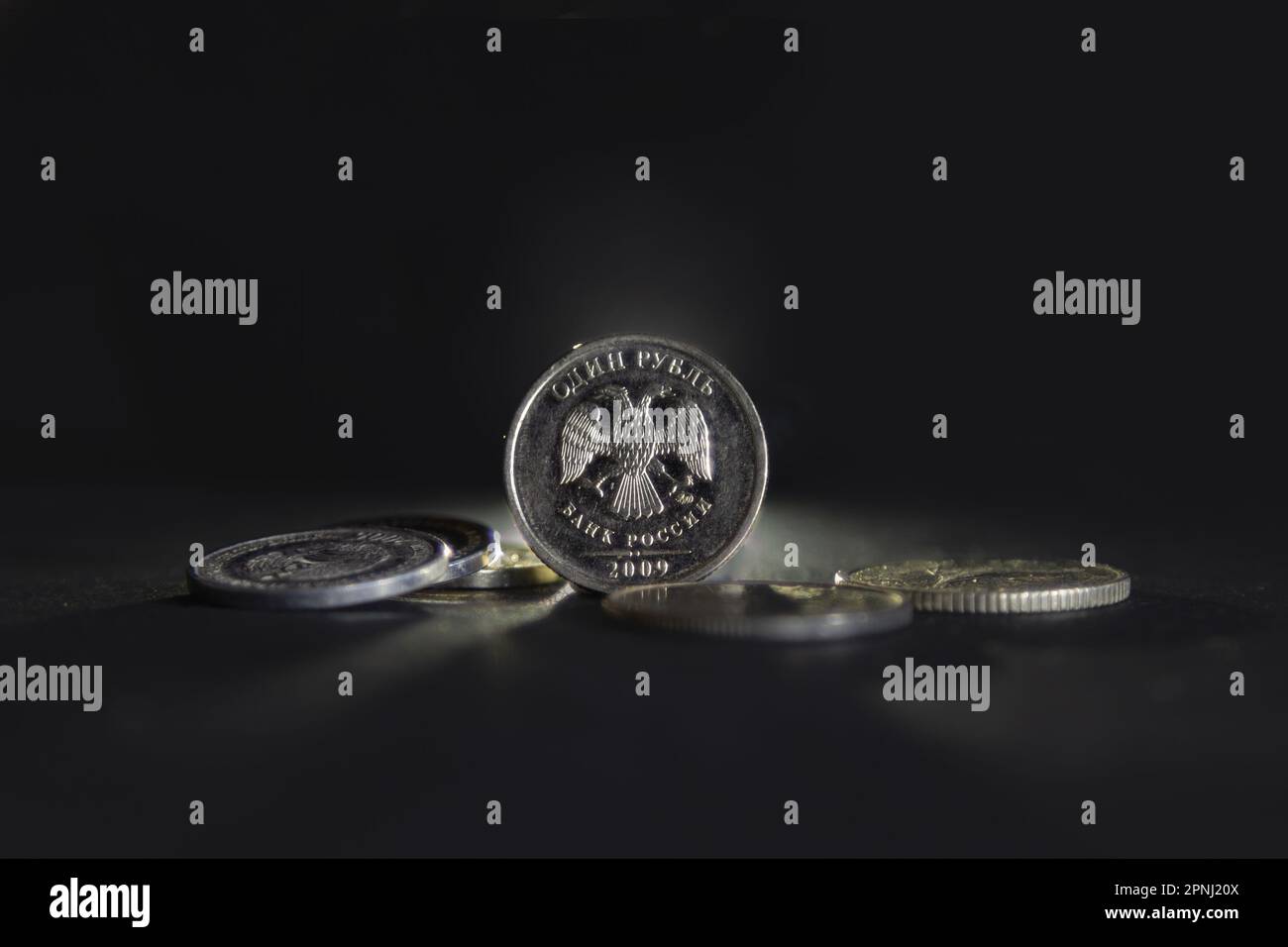 Picture of russian coins on a black background, with a focus on a coin ...
