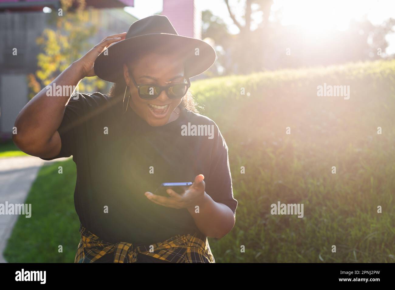 Close up portrait of happy african american young woman browsing social ...