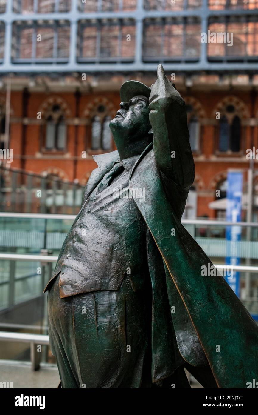 Statue of John Betjeman at St Pancras International train station London UK on upper floor Press your door to pick up your words Stock Photo