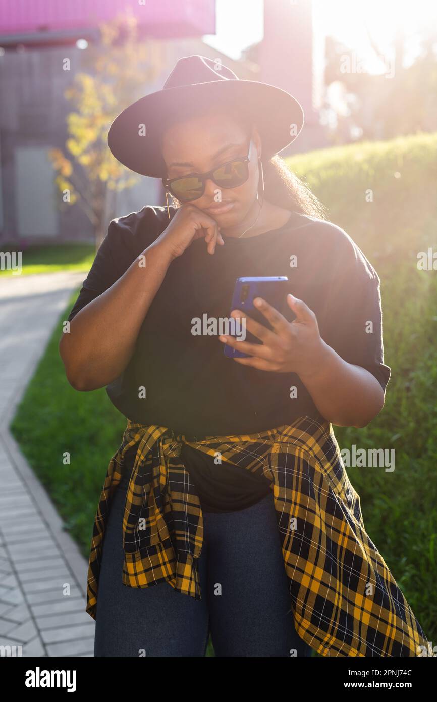 Close up portrait of happy african american young woman browsing social ...