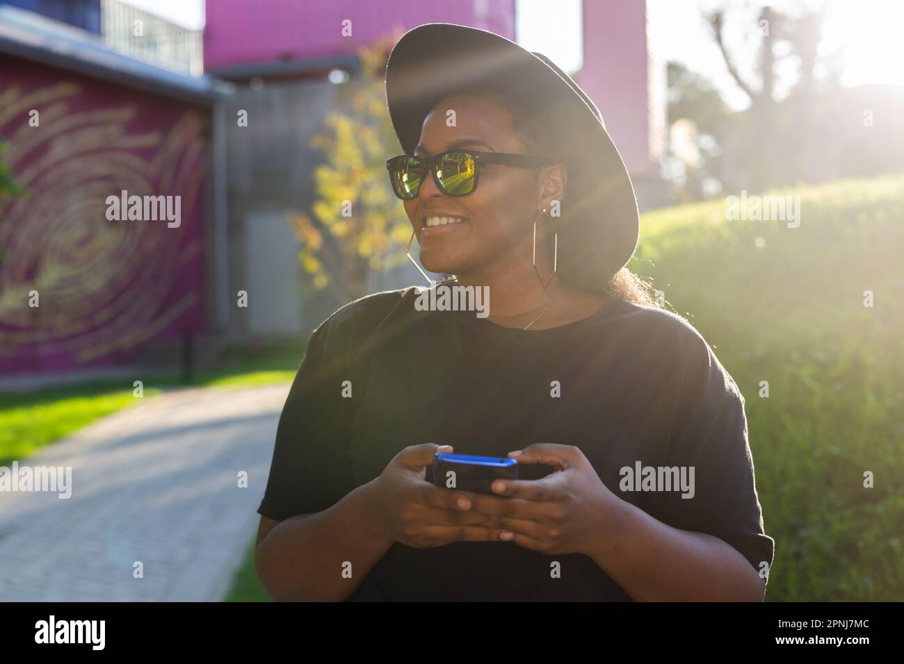 Close up portrait of happy african american young woman browsing social ...