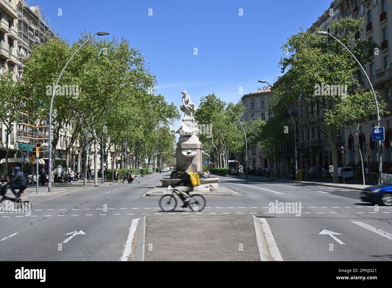 The gran via de les cortes catalanes in daily life with a historical statue as a street island Stock Photo