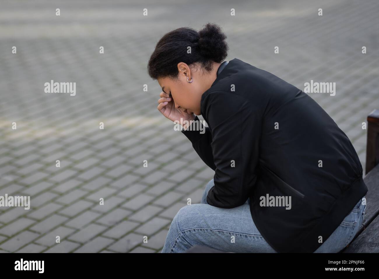 African woman sitting alone side view hi-res stock photography and ...