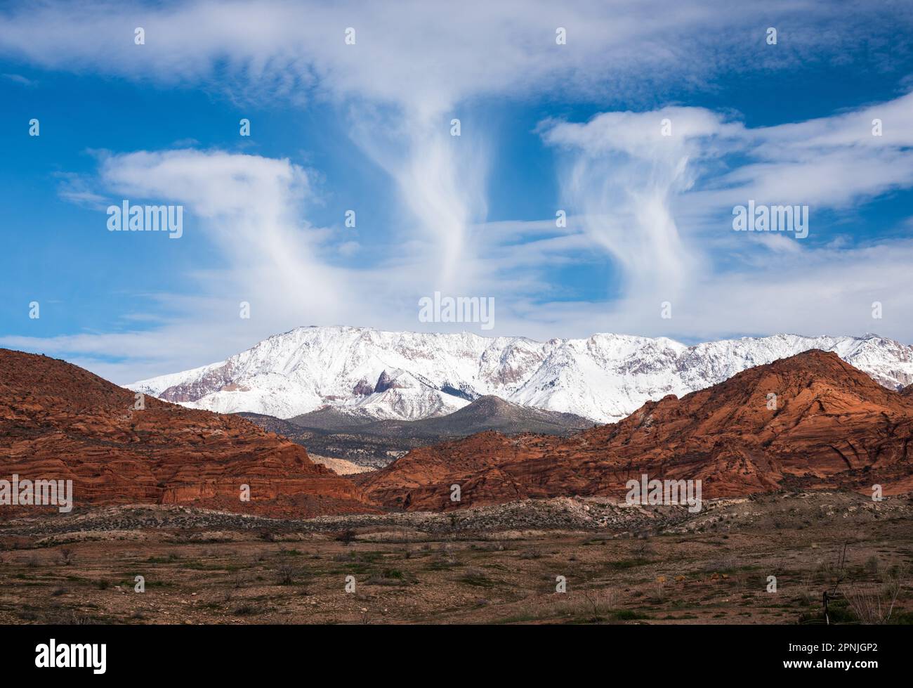 Lenticular clouds over the Snow Covered Mtns. of Pine Valley Utah.  From desert to 8000 ft in 30 miles. Stock Photo