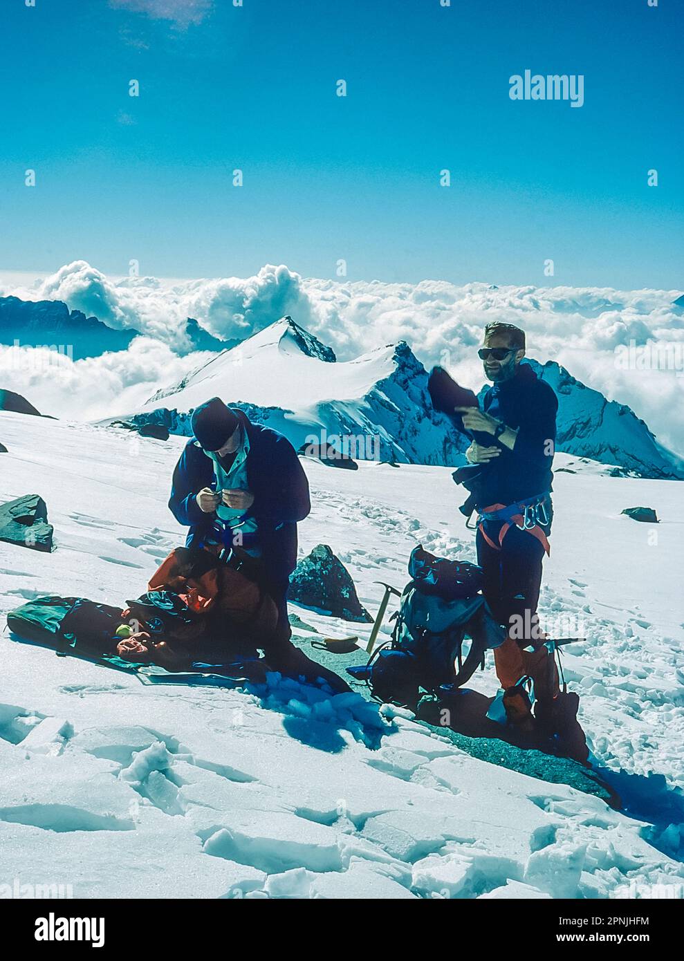 Climbers take a break on the Plateau Du'Couloir high alpine pass on the Chamonix to Zermatt Haute Route Stock Photo