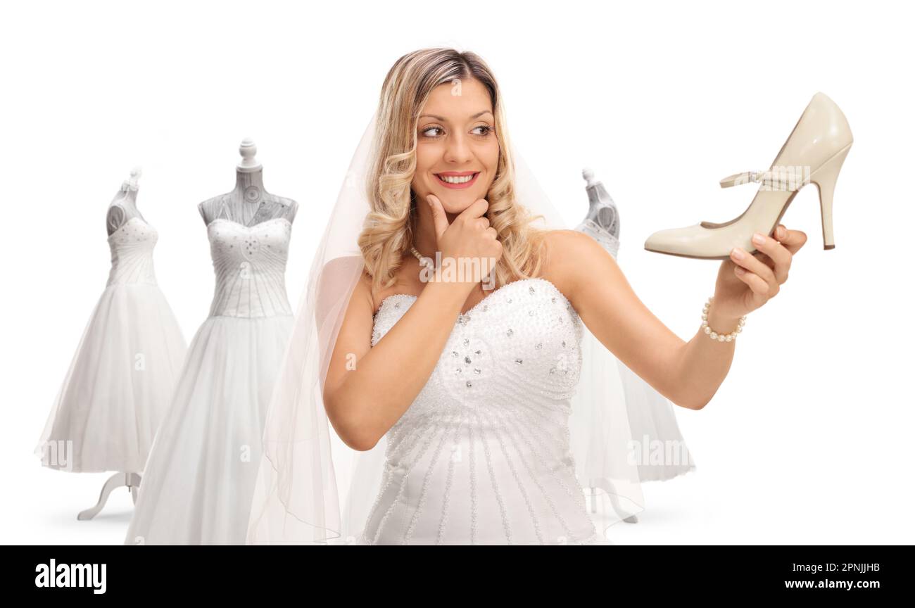 Bride choosing shoes and a dress for her wedding isolated on white background Stock Photo