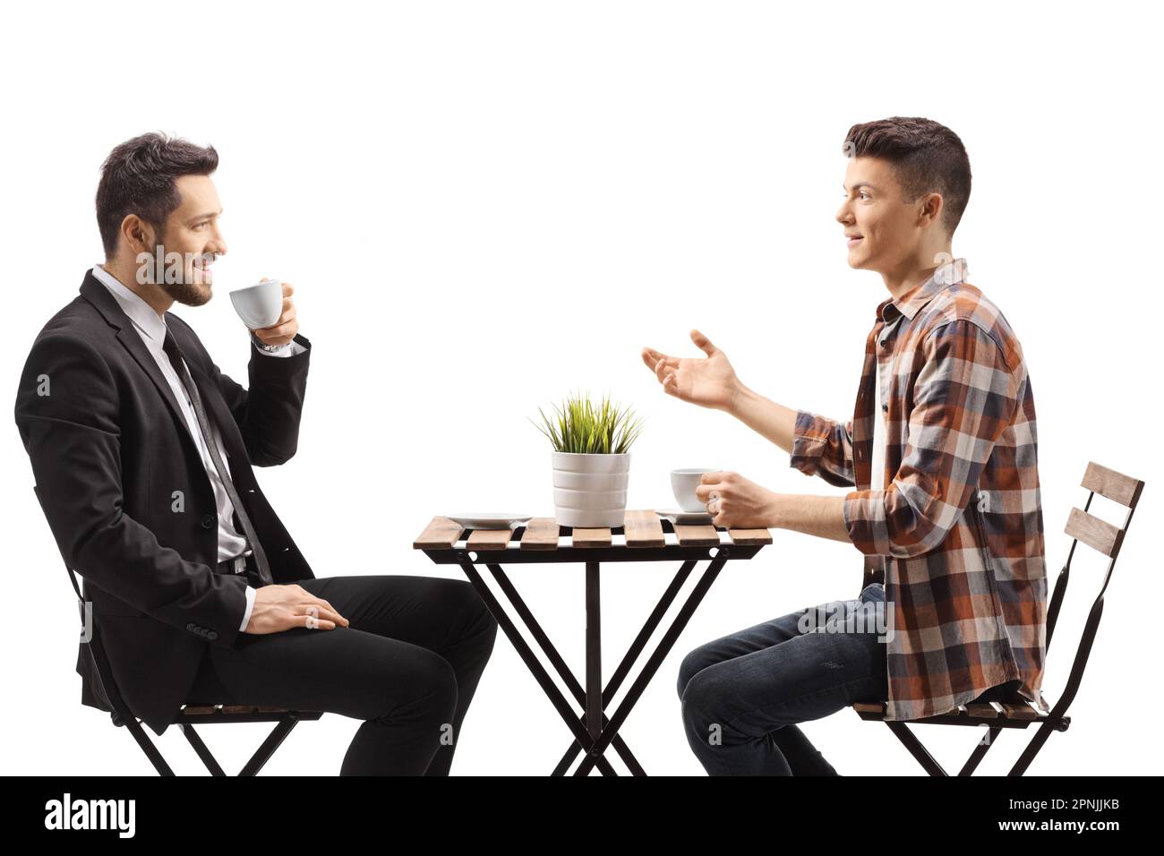 Businessman and a teenge guy sitting at a coffee table isolated on white background Stock Photo