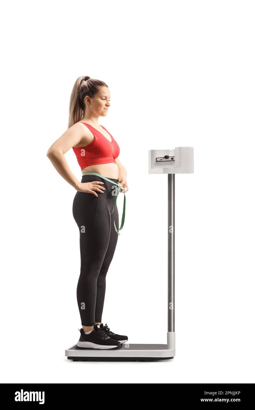 https://c8.alamy.com/comp/2PNJJKP/young-woman-in-sportswear-standing-on-a-weight-scale-and-measuring-her-waist-isolated-on-white-background-2PNJJKP.jpg