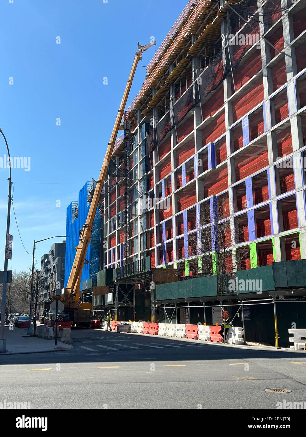 Tallk crane alongside a large under construction apartment complex in