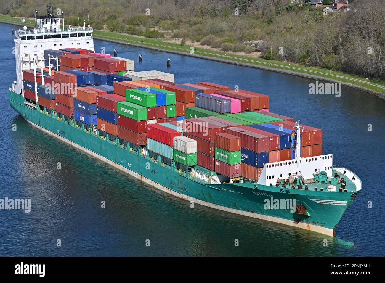 Still showing the green colors of its former owner Schepers, Rambow Shippings JUDITH is passing the Kiel Canal carrying containers for the baltic Stock Photo