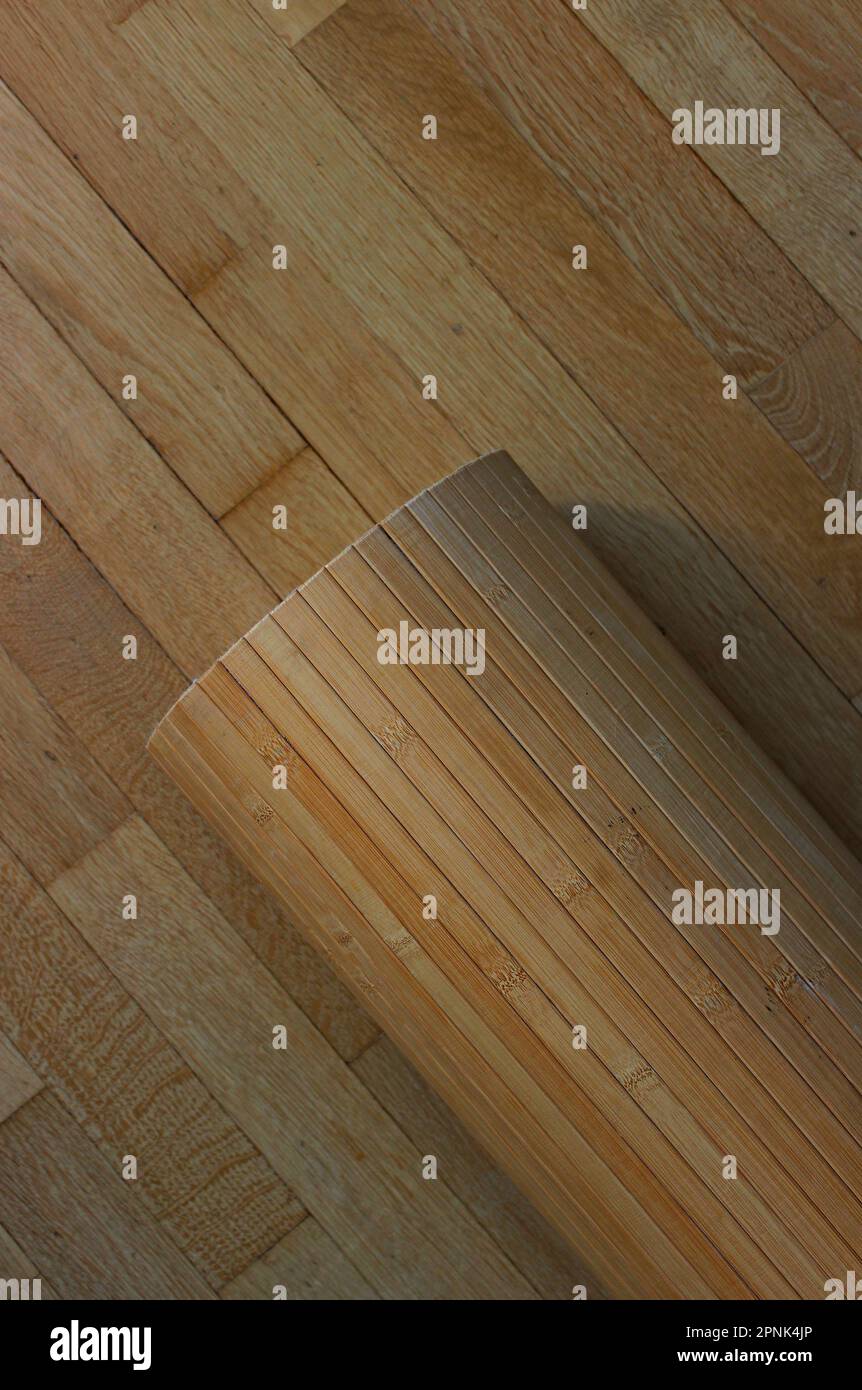 Bamboo Paneling Roll On A Wooden Planks Texture Background Stock Photo