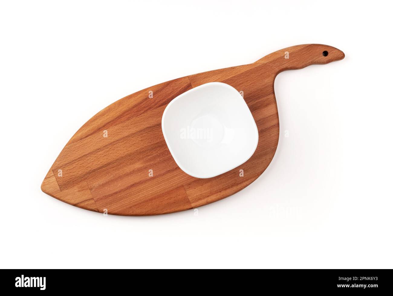 An empty white bowl on a cutting board. Blank bowl. Top view. Stock Photo