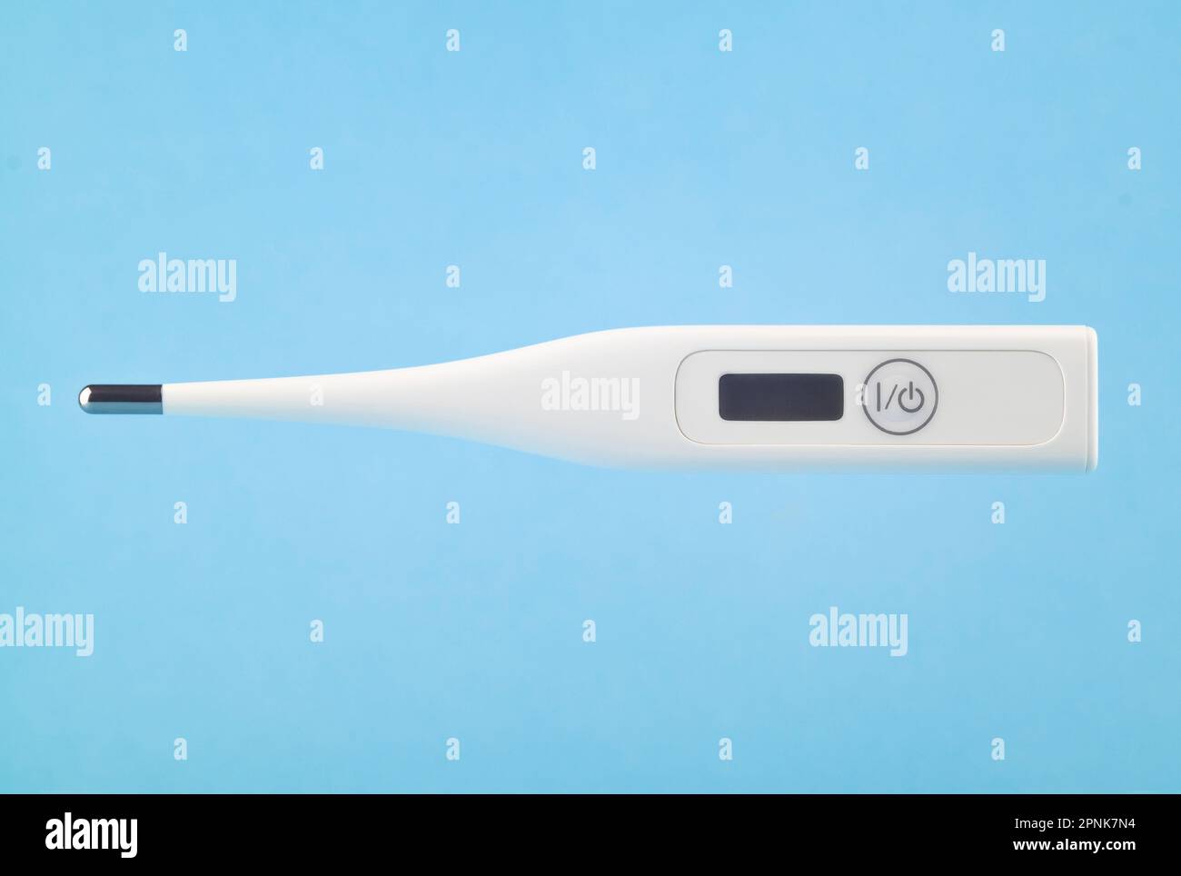Digital thermometer levitating on a blue background. Stock Photo