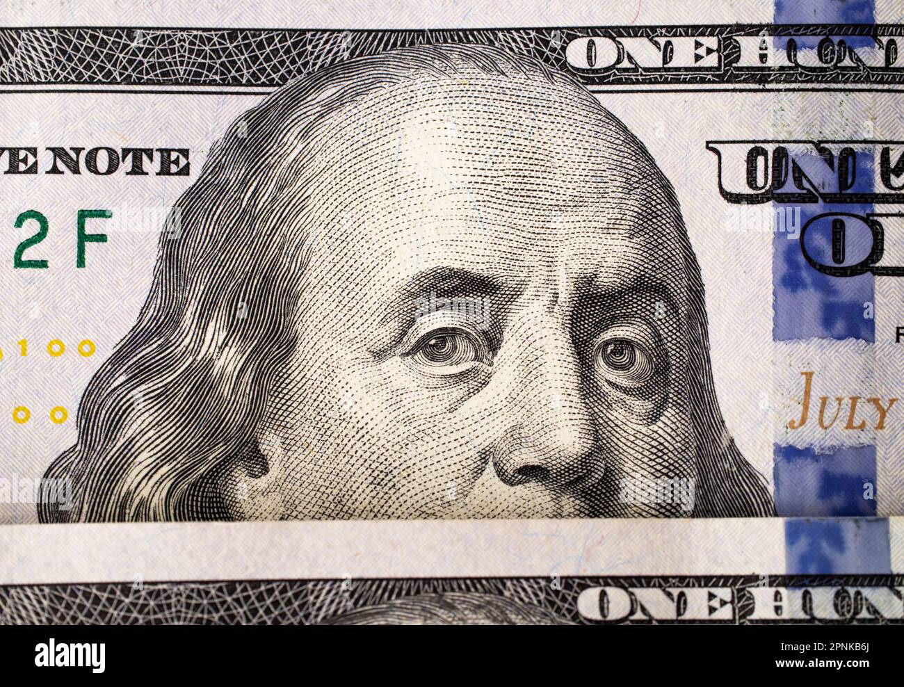Extreme close-up of one hundred bill Franklin portrait. Macro. American paper money. A $100 bill with focus on Benjamin Franklin. US banknotes Stock Photo