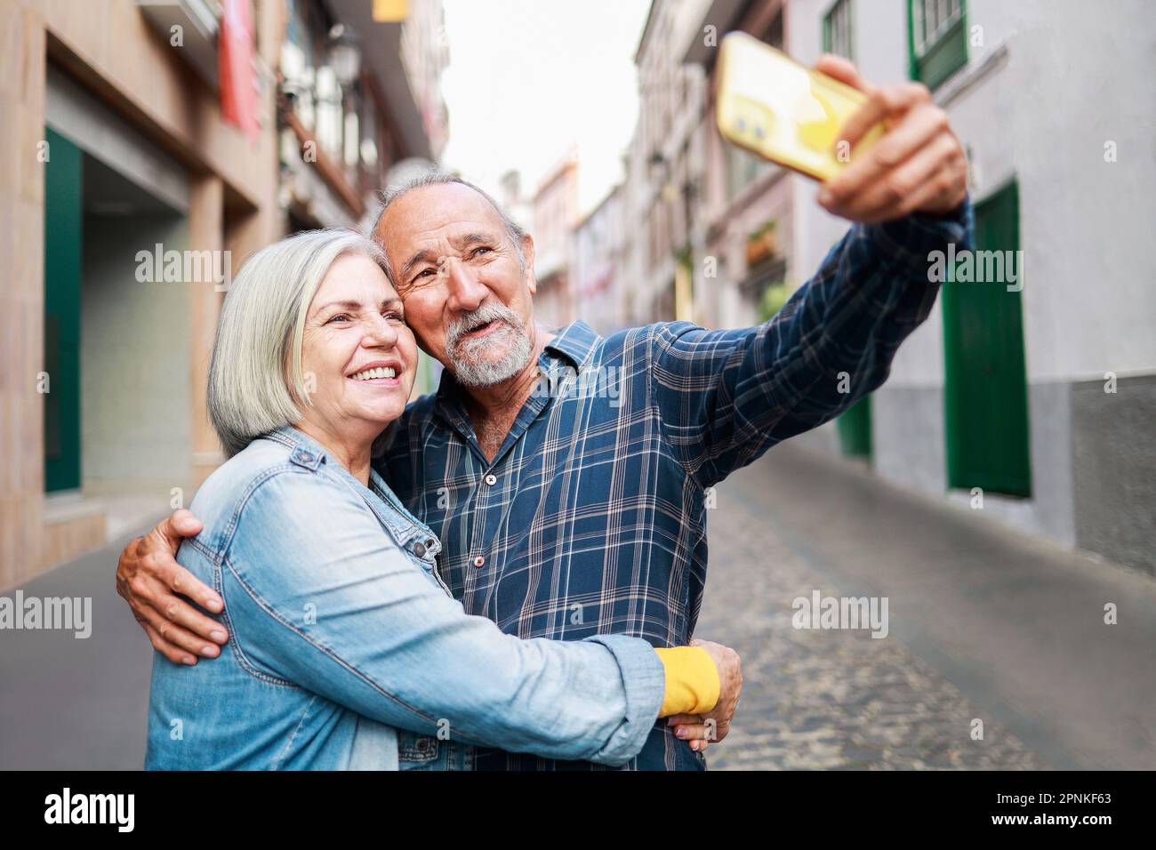 Happy senior couple taking selfie with mobile phone outdoor - Elderly ...