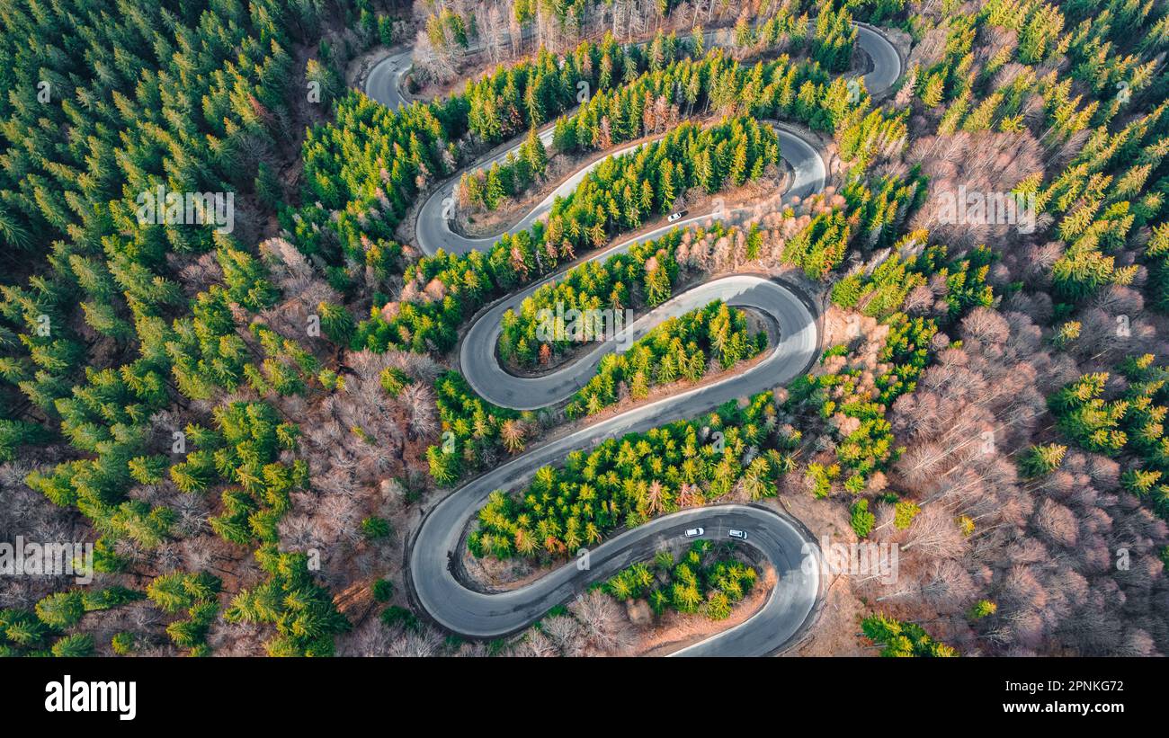 Aerial photography of a winding road in the mountains with serpentines and curves. Photography was shot from a drone at a higher altitude. Stock Photo