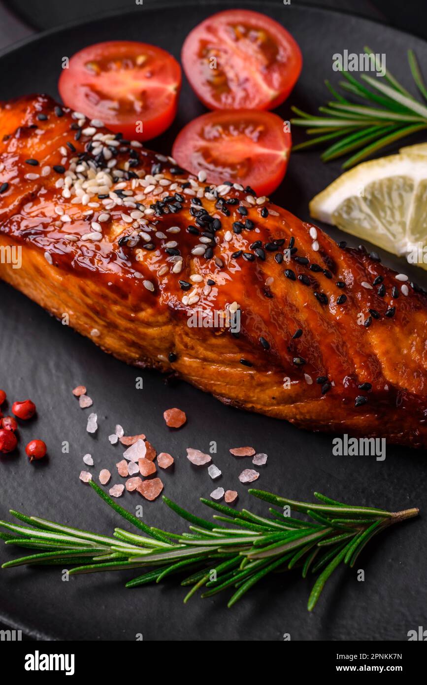 Delicious grilled red salmon fish with sauce, sesame seeds, spices and ...