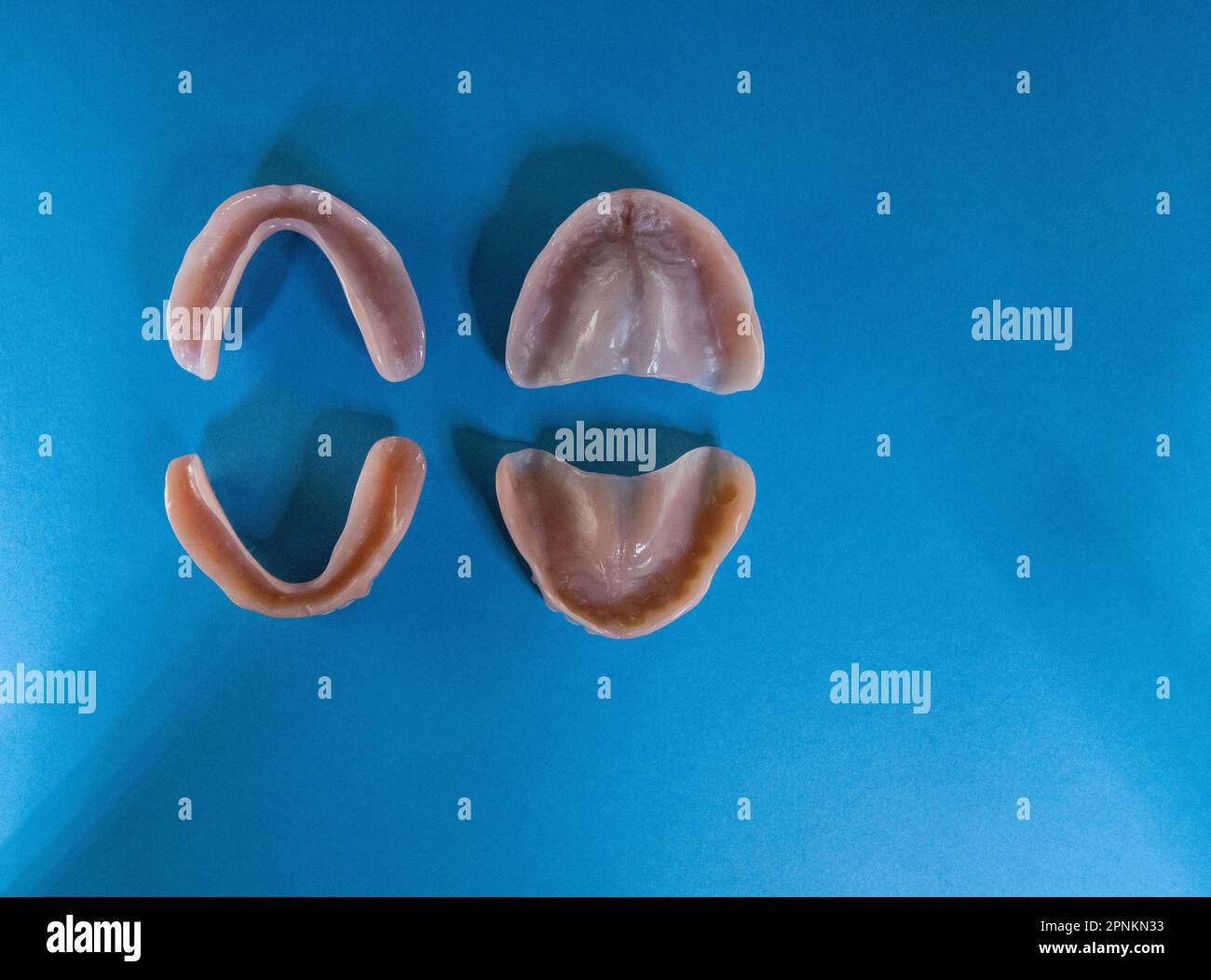 two pair of Dentures (top and bottom) removable false teeth made of