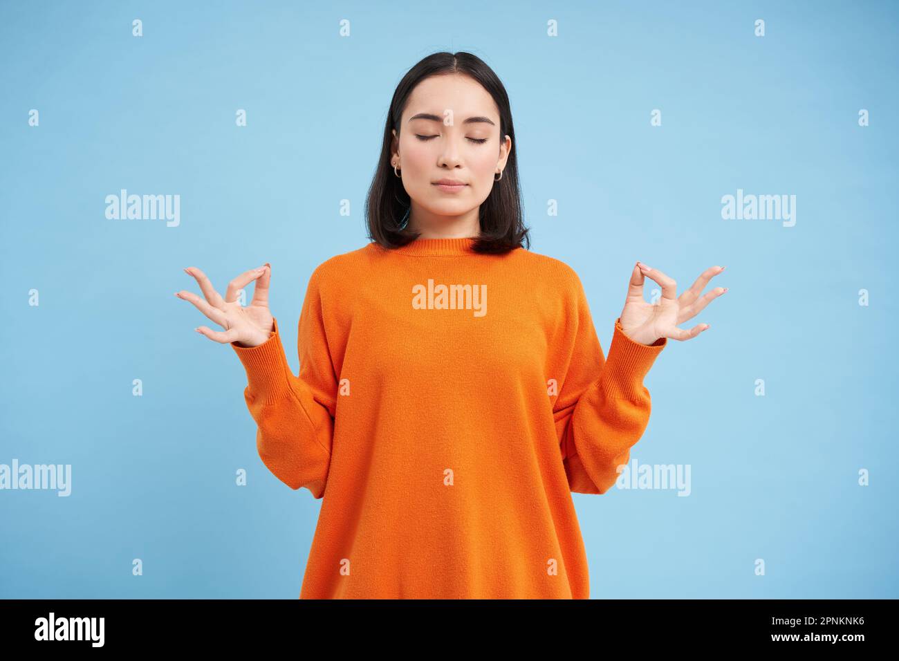 Emotions under control, zen. Young calm asian woman meditating
