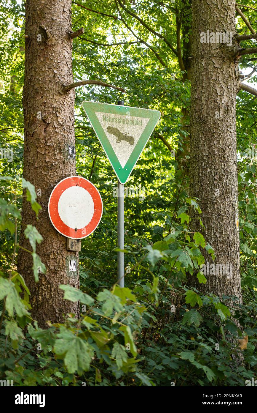 Signs 'Naturschutzgebiet' and 'No entry!' on the edge of a forest, marking a nature reserve and conservation area, Germany Stock Photo