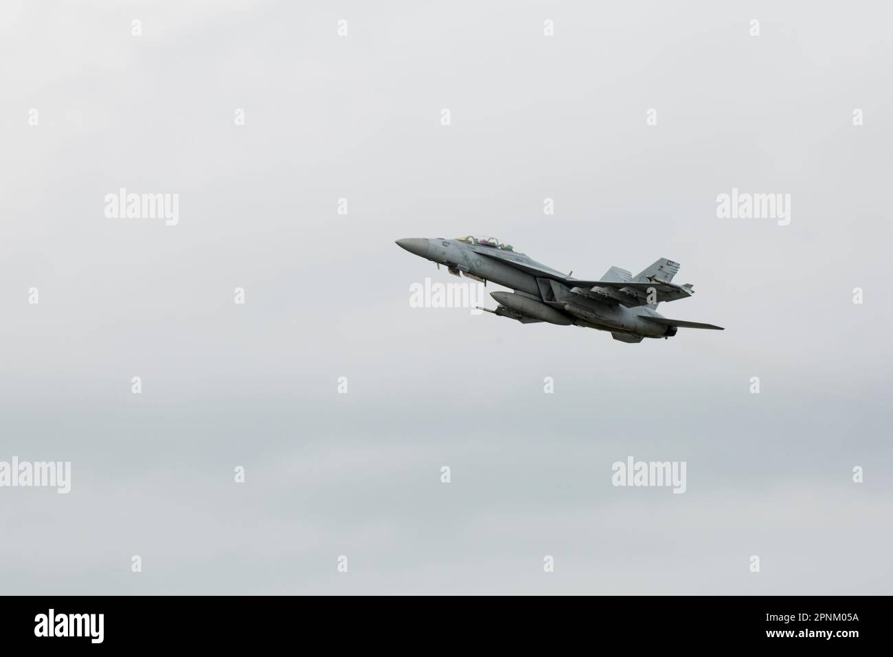 A U.S. Navy F/A‐18E Super Hornet aircraft with Strike Fighter Squadron 115 takes off in support of a live‐fire exercise from Marine Corps Air Station Iwakuni, Japan, April 12, 2023. Marines with Marine Aircraft Group 12 and U.S. Navy Sailors with Carrier Air Wing Five conducted a joint, live missile shoot over the Pacific to sustain their high‐level of weapon proficiency, while serving as forward‐postured aviation units in the Indo‐Pacific region. (U.S. Marine Corps photo by Lance Cpl. Samantha Rodriguez) Stock Photo