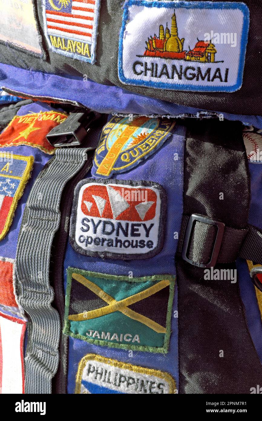 Patches of destinations visited are sewn onto a well-worn budget travelers backpack with destinations including Chiang Mai, Sydney, Malaysia, and Jamaica.  The patches are part of the identity of the backpacker and subsequently the identity of a global citizen. Stock Photo