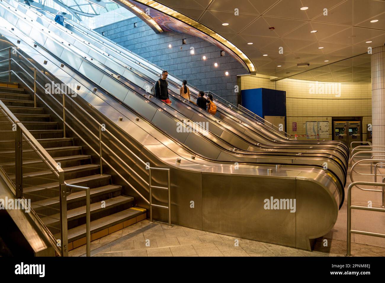 New York, NY - USA - April 14, 2023 View of commuters riding escalators to the entrance to the 34 Street-Hudson Yards Subway Station, the western term Stock Photo