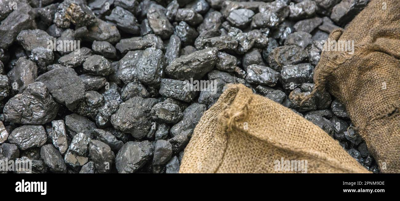 Lumps of coal and sacks Stock Photo