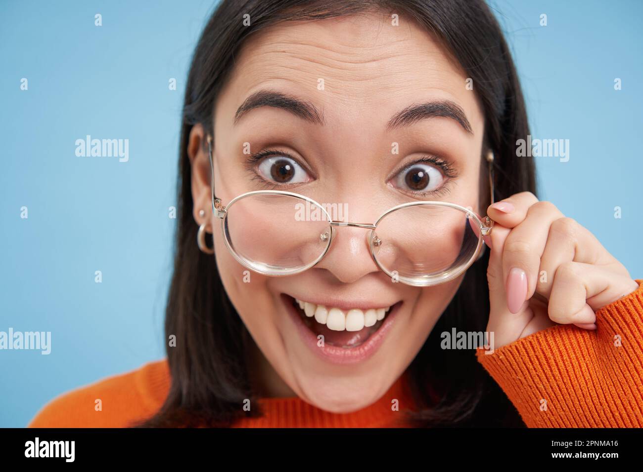 Close up portrait of amazed girl, looks closer at camera in glasses ...
