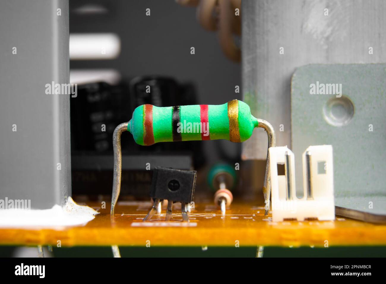 Carbon film resistor with a green color on electronics circuit board of