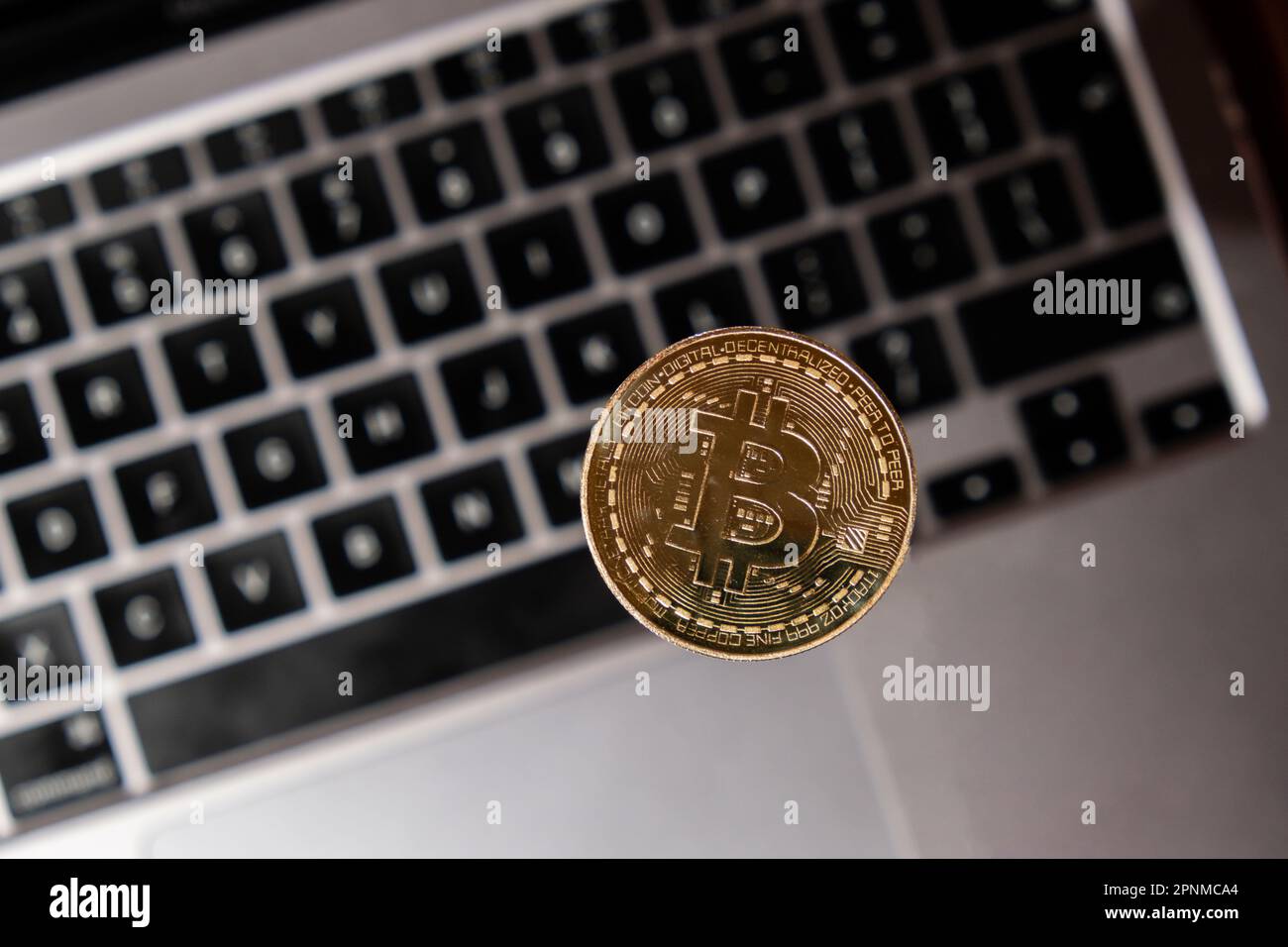 Bitcoin gold coin on keyboard of laptop Mining trading concept. BTC golden money. Worldwide virtual internet Cryptocurrency or crypto digital payment system. Digital coin money farm in digital cyberspace Stock Photo