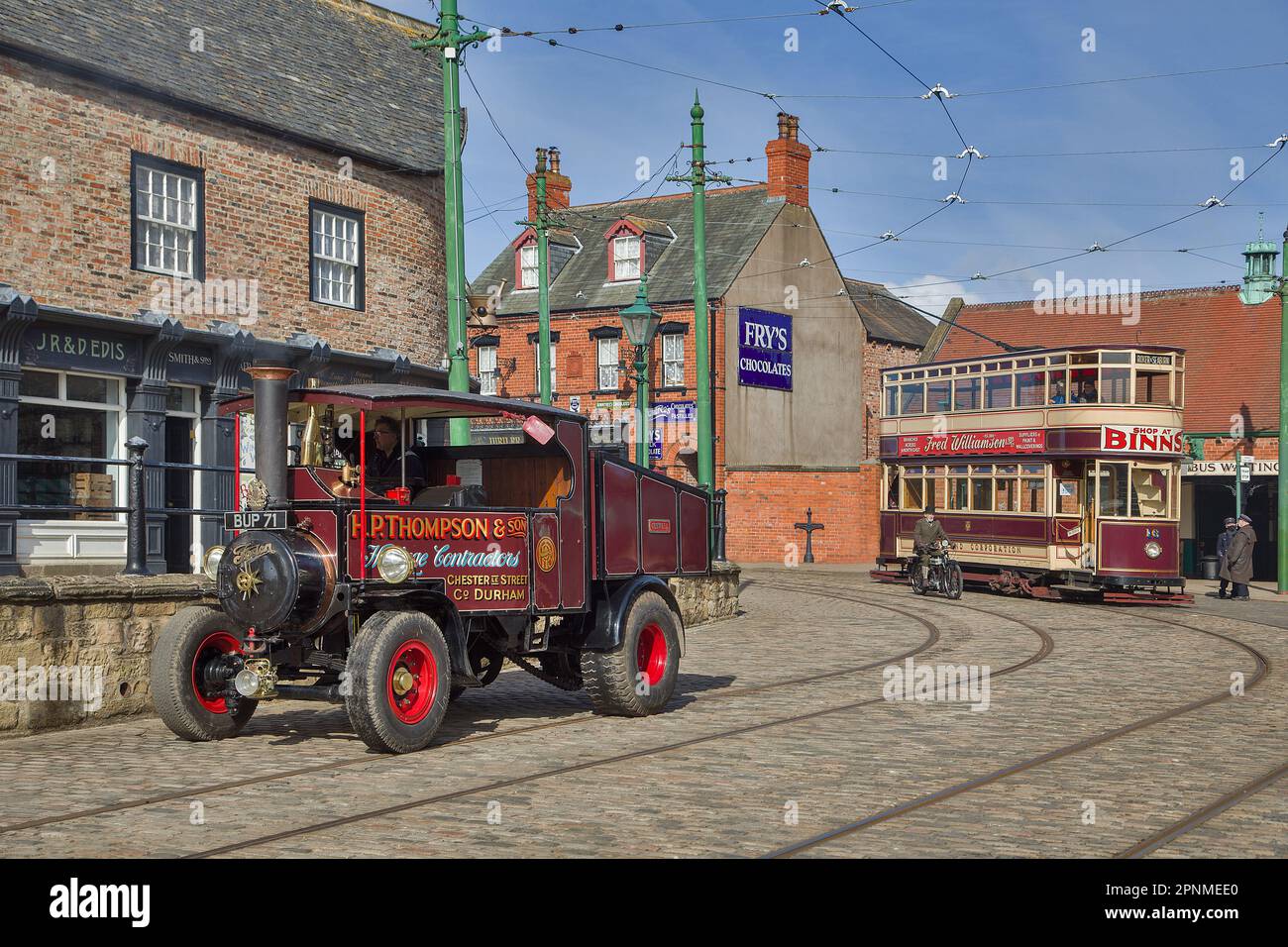 A tram and a steam wagon in Beamish High Street Stock Photo