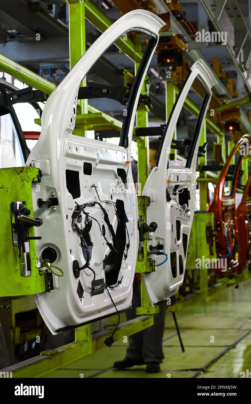 Car doors painted white color in assembling Stock Photo Alamy
