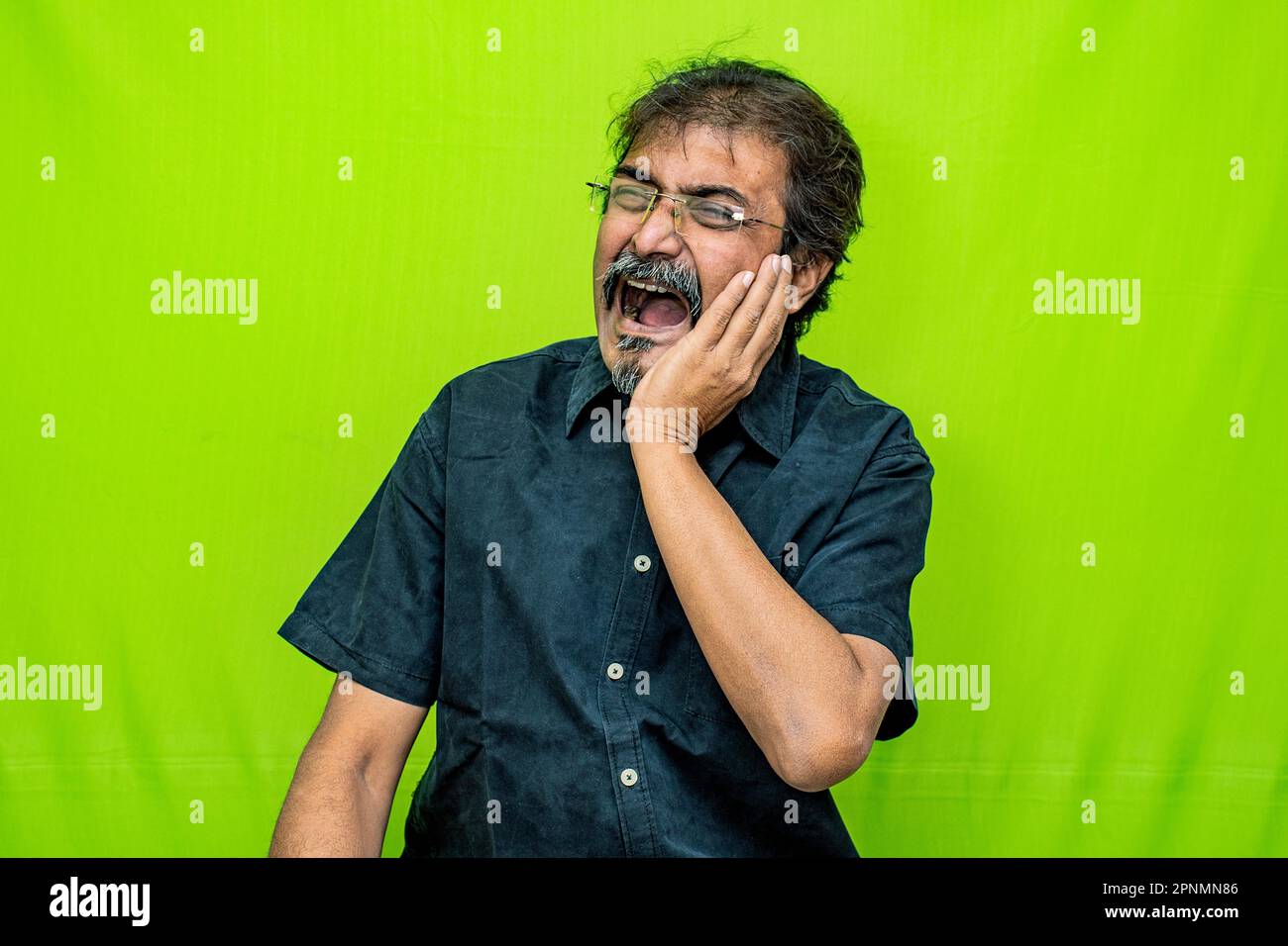 The welldressed Indian man, wearing a black shirt, appears to be