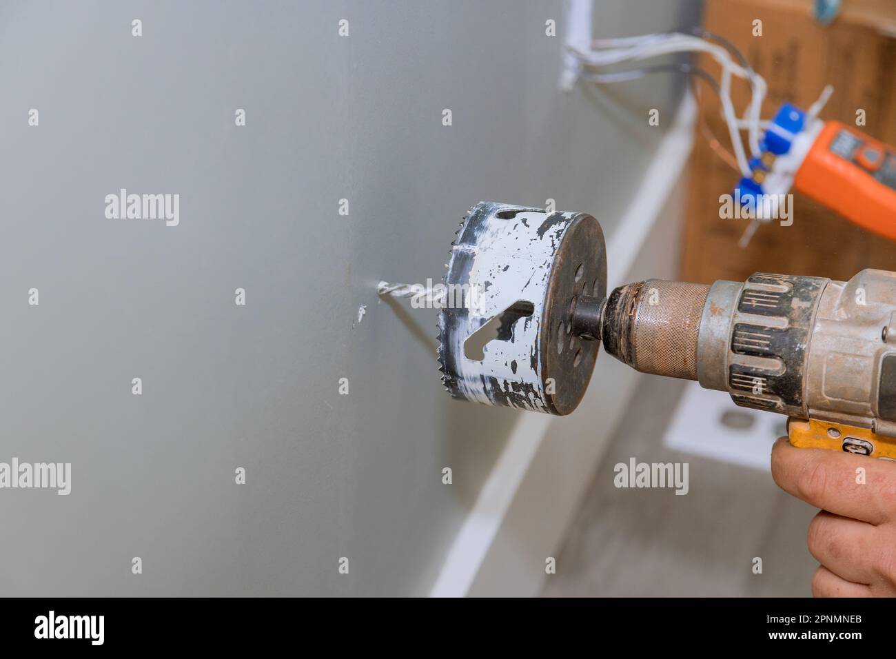 Drilling drywall for installation of electrical wires in wall is one