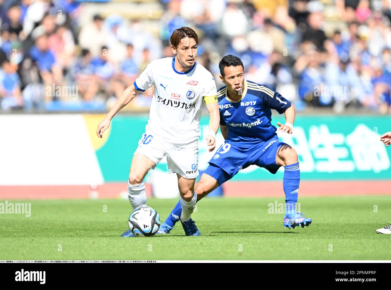 Tokyo, Japan. 16th Apr, 2023. Oita Trinita's Naoki Nomura, left, and FC ...