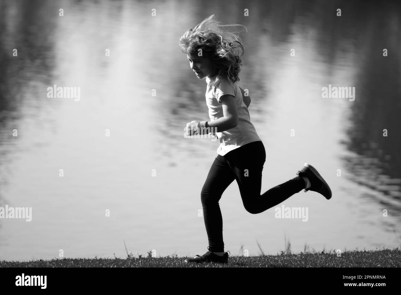 Kid runners run on lawn in park. Child running outdoor. Healthy sport