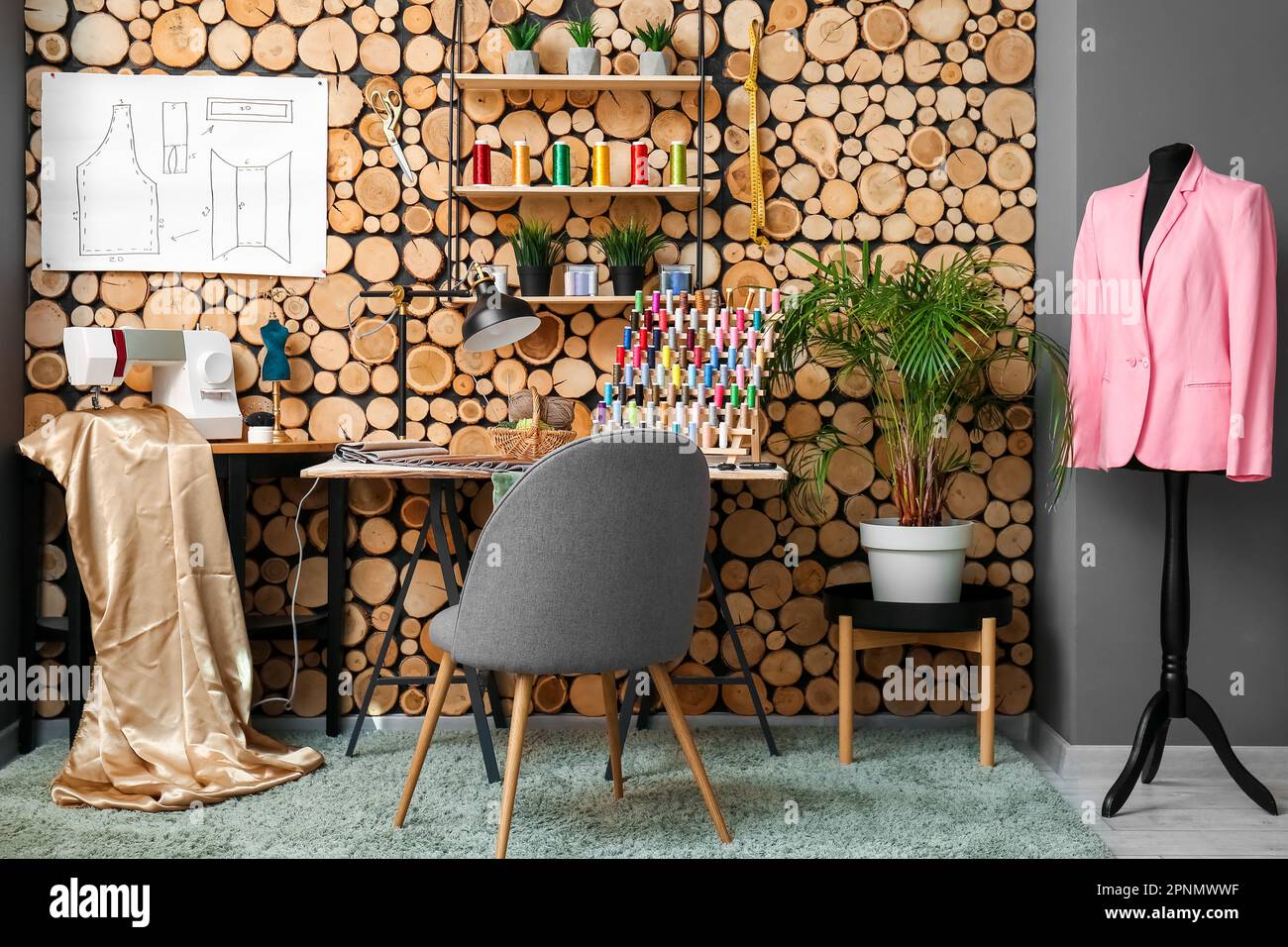 Interior of atelier with tailor's workplace, shelf and mannequin Stock