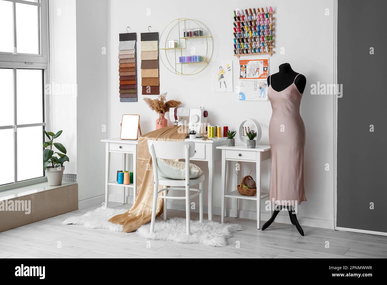Interior of atelier with tailor's workplace, shelf and mannequin Stock Photo Alamy