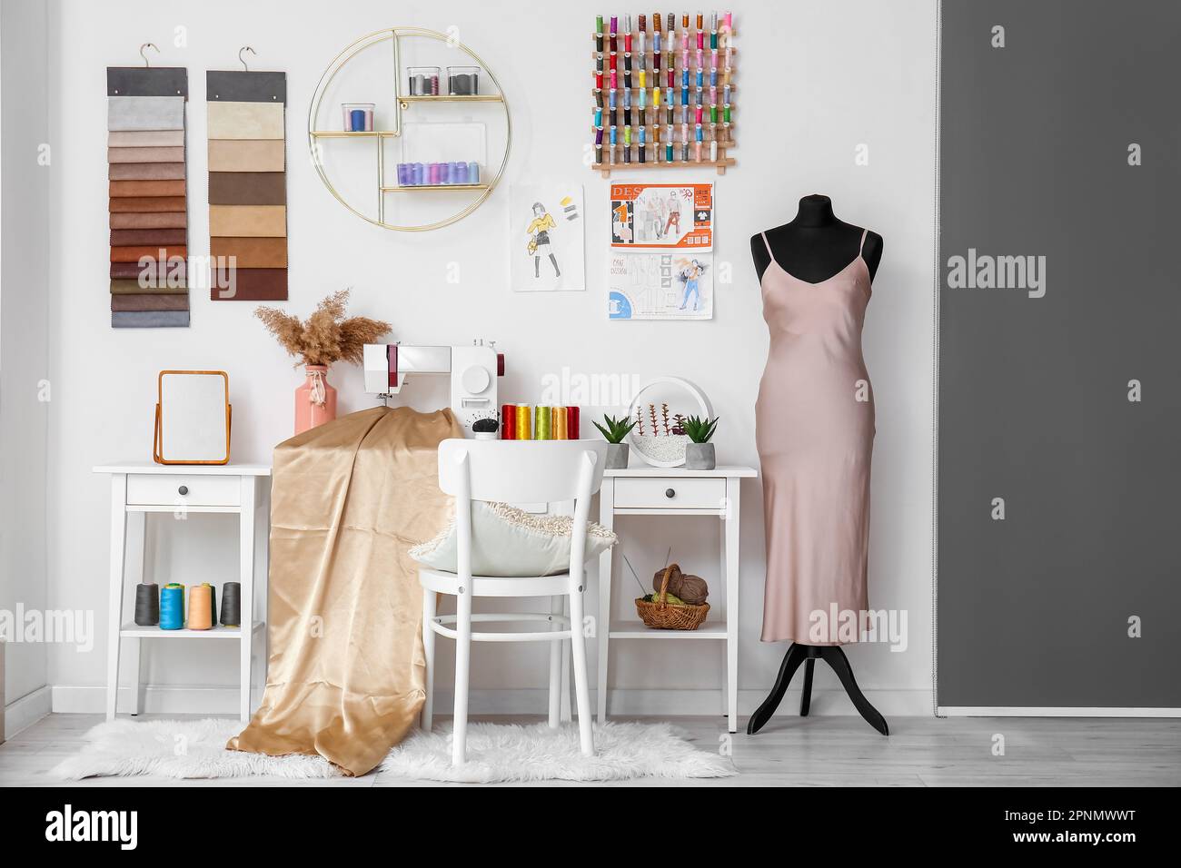 Interior of atelier with tailor's workplace, shelf and mannequin Stock