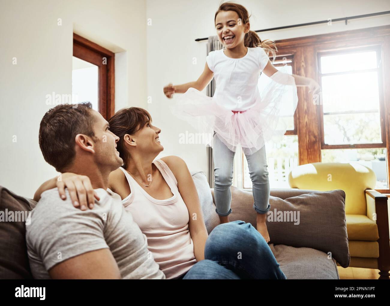 Watch how high I can jump. a little girl jumping on the couch while