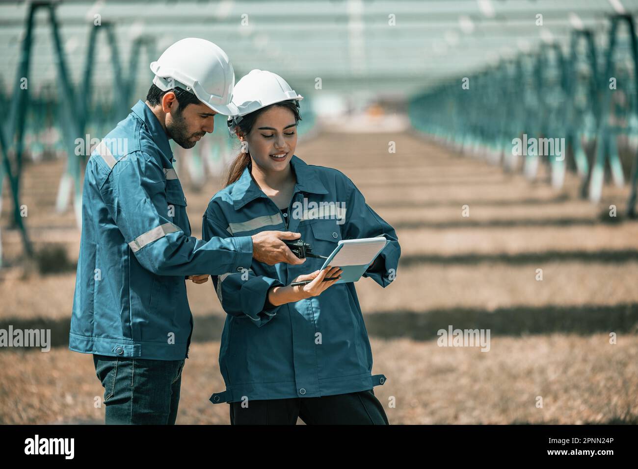Solar design engineers visually inspect photovoltaic array installation ...